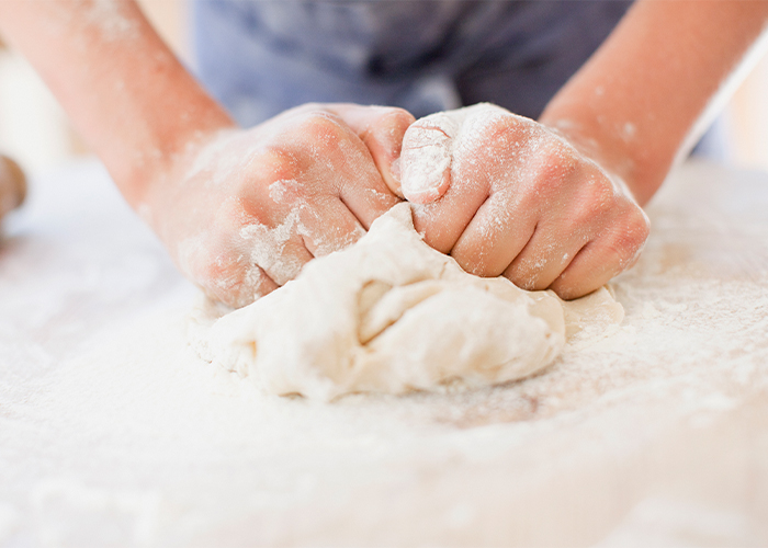 A pair of hand kneading dough